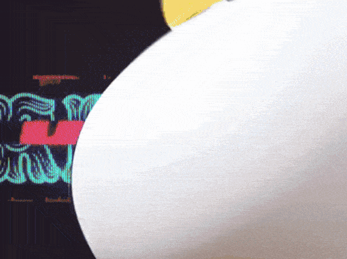 a close up of a white object with a screen behind it that says ' s ' on it