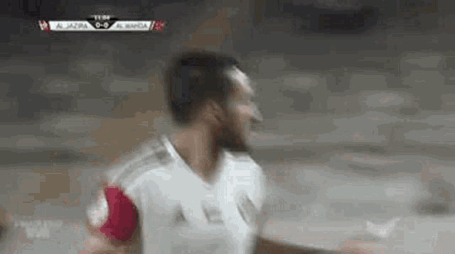 a soccer player is celebrating a goal during a soccer game .