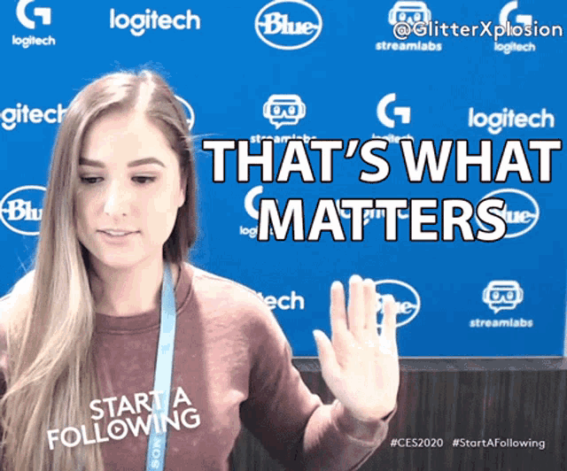 a woman says that 's what matters in front of a blue backdrop