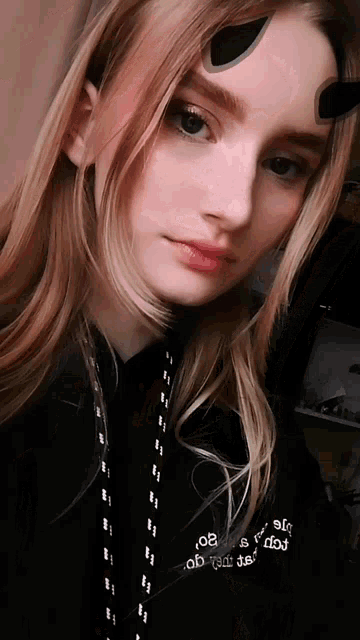 a girl wearing a black hoodie with the number 08 on the back