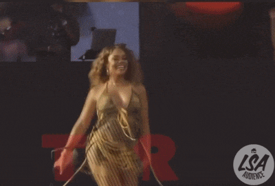 a woman dancing in front of a lsa audience logo