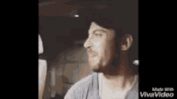 a man is sitting in the back seat of a car .