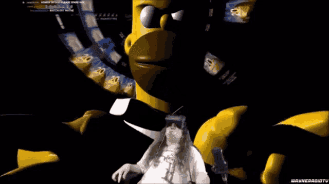 a man wearing a virtual reality headset is sitting in front of a homer simpson