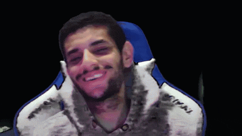 a man sitting in a chair with a jacket that says miami