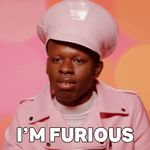 a man wearing a pink jacket and hat says " i 'm furious "
