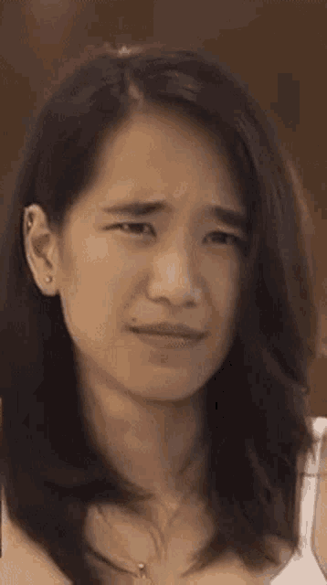 a close up of a woman making a funny face with her mouth open .