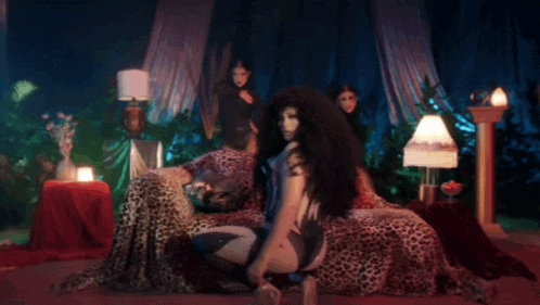 a woman in a corset is sitting on a leopard print bed