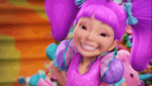 a barbie doll with purple hair and a pink shirt is laughing and smiling .