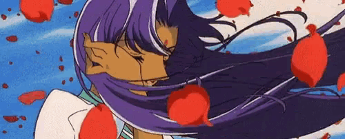 a woman with long purple hair is kissing a man with red petals falling from her hair .