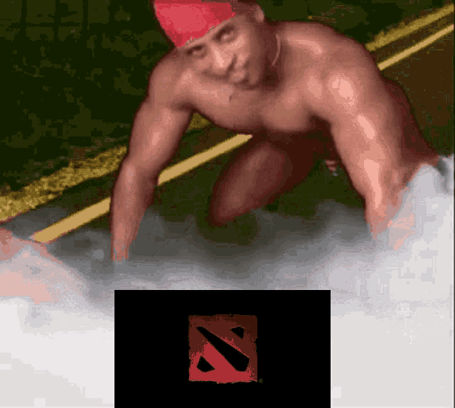 a shirtless man in a red hat is kneeling down next to a n logo