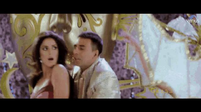 a man and a woman are dancing in front of a colorful background with the name coral on the bottom