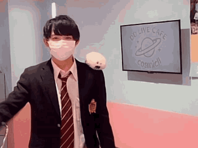 a man in a suit and tie is standing in front of a sign that says od live cafe