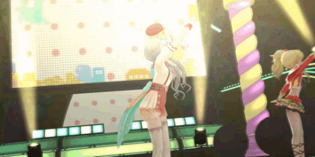 two anime girls are dancing on stage in front of a large screen