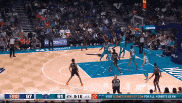 a basketball game is being played in front of a crowd and the score is 91 to 97