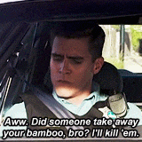 a man is sitting in a car with a seat belt on and talking to someone .