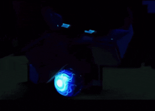 a dark room with a blue light in the middle of the room