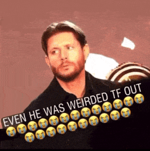 a man with a beard is standing in front of a sign that says " even he was weirded tf out " .