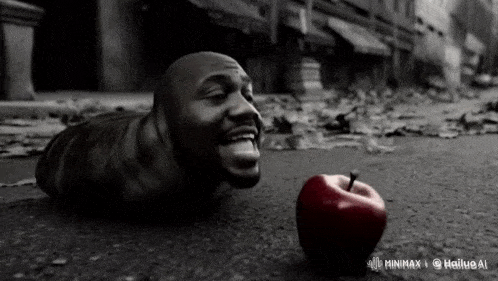 a black and white photo of a man laying on the ground next to a red apple that says minimax on the bottom