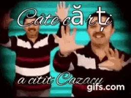 a man with a mustache is waving his hands in front of a blue background that says cate ca ti