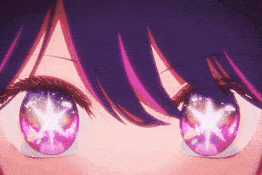 a close up of a person 's eyes with purple hair