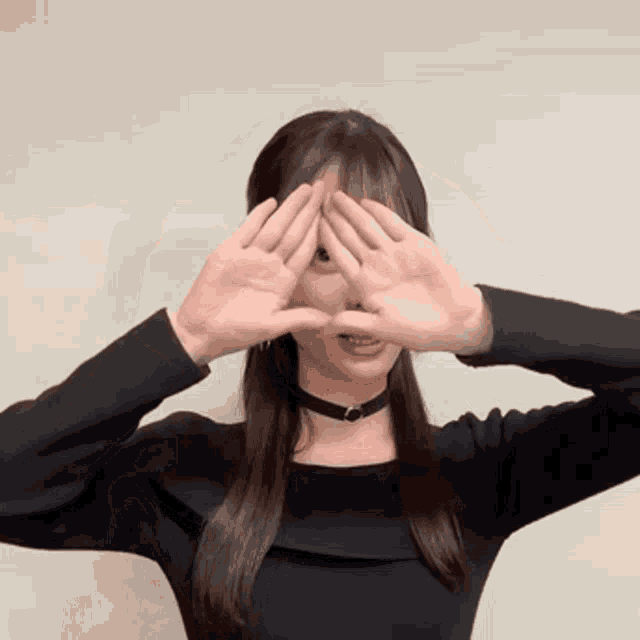 a woman covering her eyes with her hands