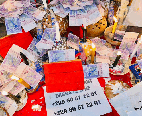 a bunch of money and candles on a table
