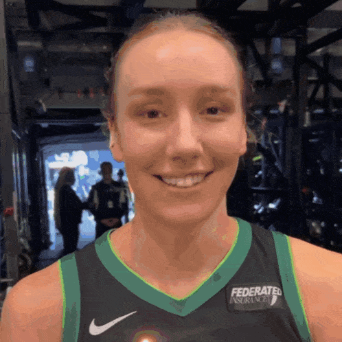 a female basketball player is wearing a jersey that says federated insurance on it