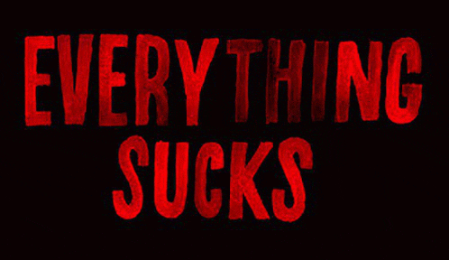 a black background with red text that says `` everything sucks ''