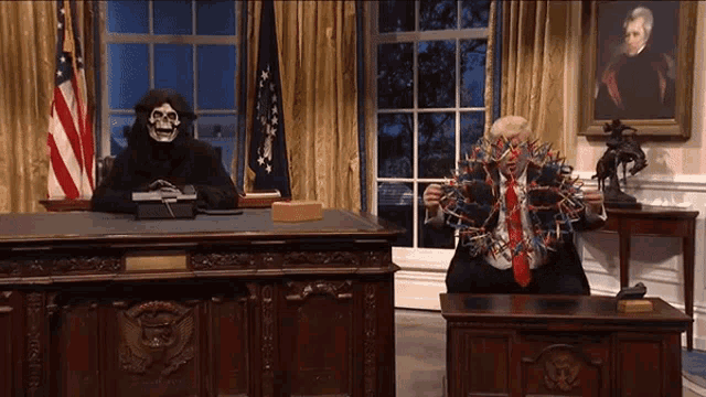 a grim reaper is sitting at a desk next to a man in a suit and tie