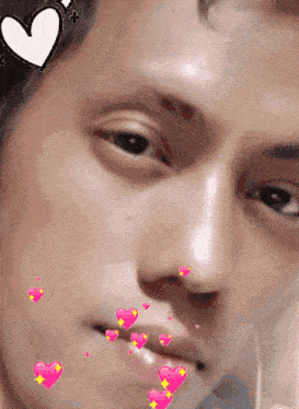 a close up of a person 's face with hearts coming out of his mouth