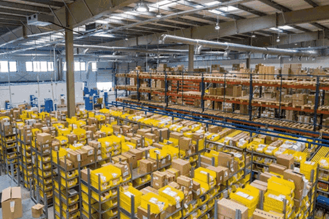 a large warehouse filled with lots of boxes including one that says ' dhl ' on it