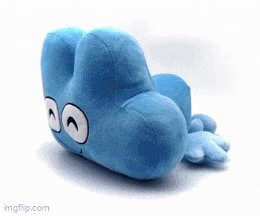 a blue stuffed animal with a face on it is laying on a white surface .