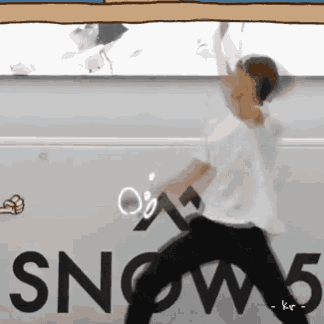 a person is standing in front of a sign that says snow5