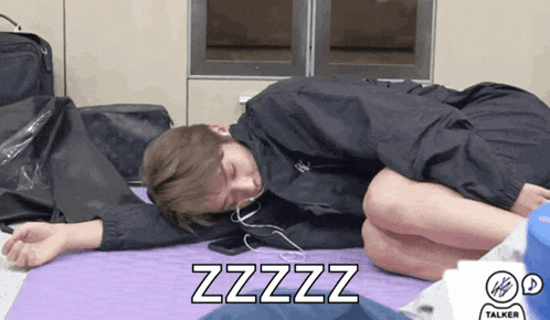 a person laying on a yoga mat with the word zzzz on the bottom