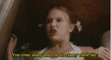 a baby is laying on a bed and saying `` you come along and you wreck my whole life '' .