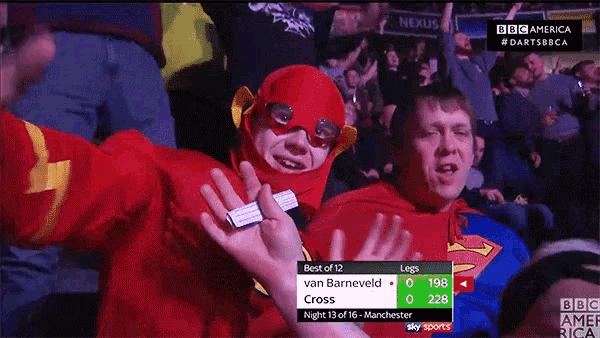 a man in a flash costume stands next to a man dressed as superman
