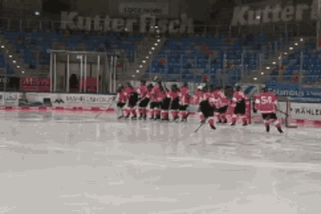 a hockey game is being played in front of a banner that says kutter fisch