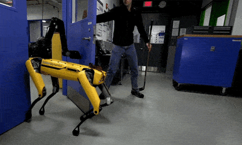 a man is standing next to a yellow robot that says dynamic on it