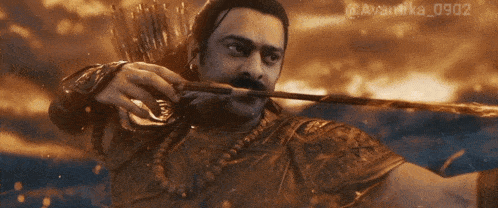a man is holding a bow and arrow in his mouth with the numbers 0902 on the bottom