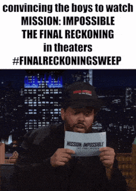 a man is holding a piece of paper that says mission impossible the final reckoning in theaters