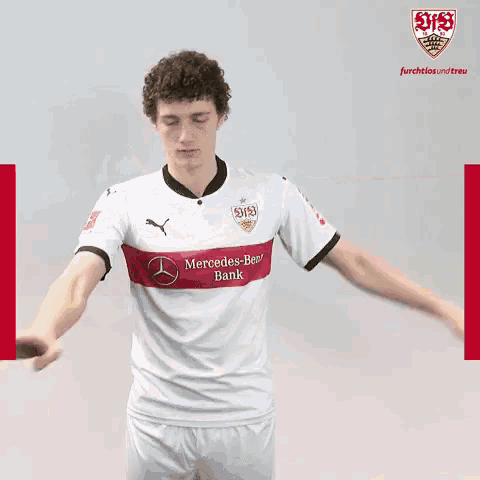 a man in a mercedes-benz bank jersey does a dab