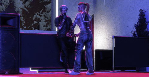 a man and a woman are standing next to each other in front of a speaker that says behringer