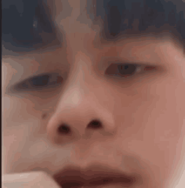 a close up of a man 's face with his eyes closed