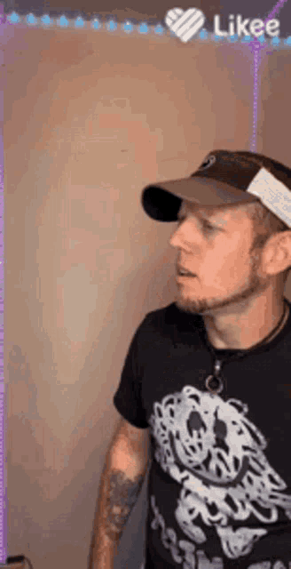 a man wearing a hat and a t-shirt with a skeleton on it