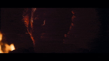 a close up of a person 's face with flames coming out of it
