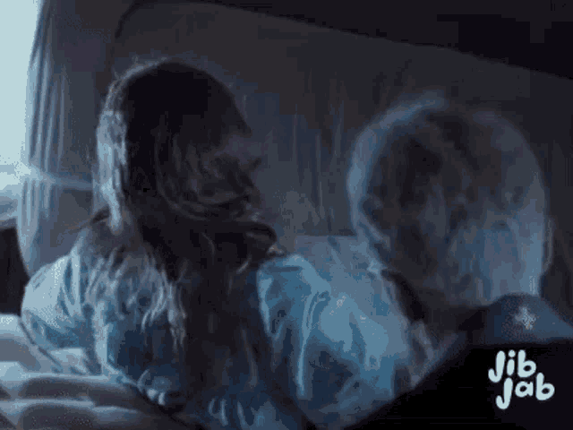 a little girl is laying on a bed with a ghost .