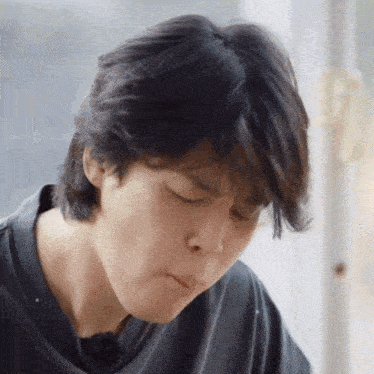 a close up of a man 's face with his eyes closed and his mouth open
