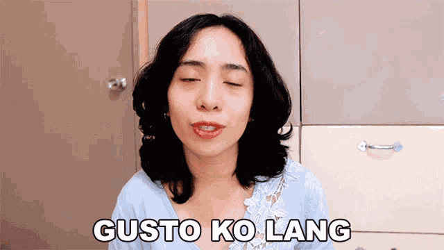 a woman with her eyes closed has gusto ko lang written on her chest