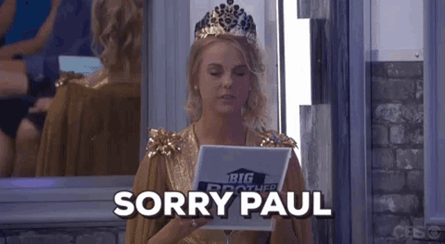 a woman in a crown is holding a piece of paper that says sorry paul