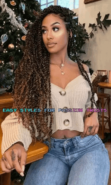 a woman with braids is sitting in front of a christmas tree with the words easy styles for passion twists above her